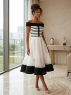 Black cropped knit top with decorative button detail