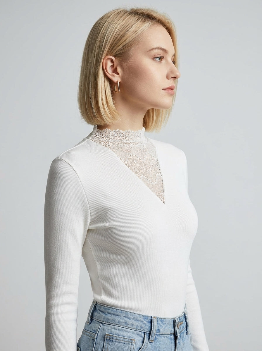 Slim-fit white blouse featuring feminine lace accents