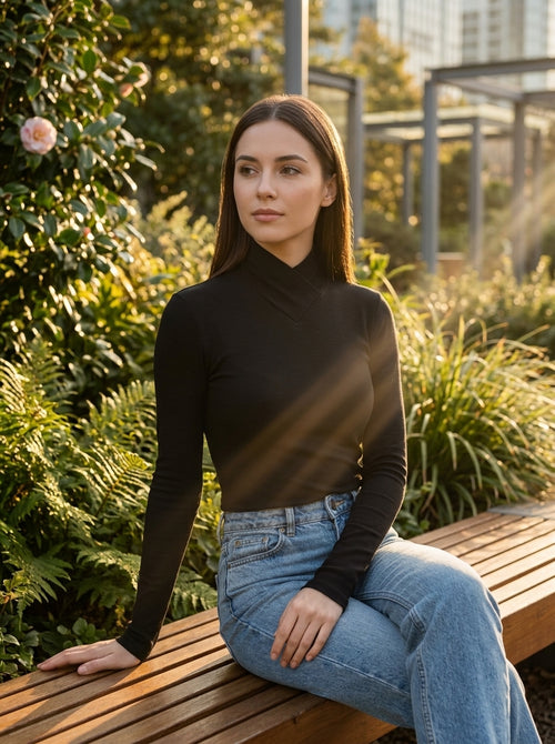 Elegant black long sleeve top with faux wrap neckline